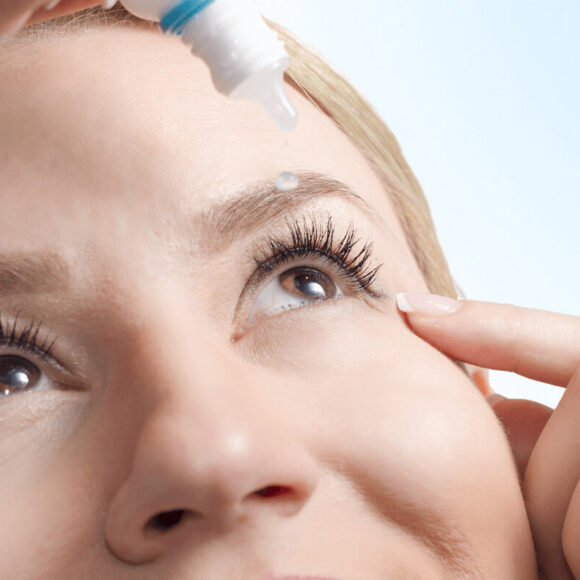 Woman putting in eye drops